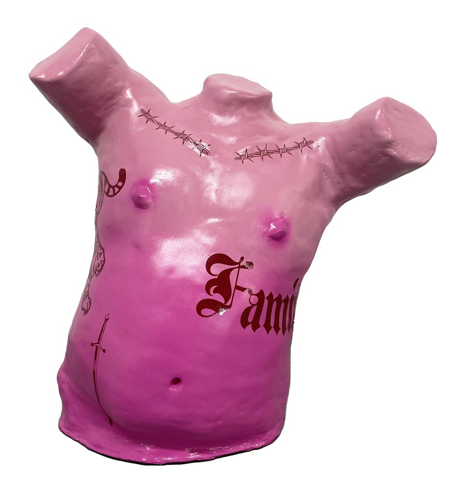 Image: On a white background, Palacios’ sculpture, Family Man. It is a bright pink ombre torso with no arms and tattoos. It is made out of acrylic and vinyl on plaster. Photo courtesy of the artist.