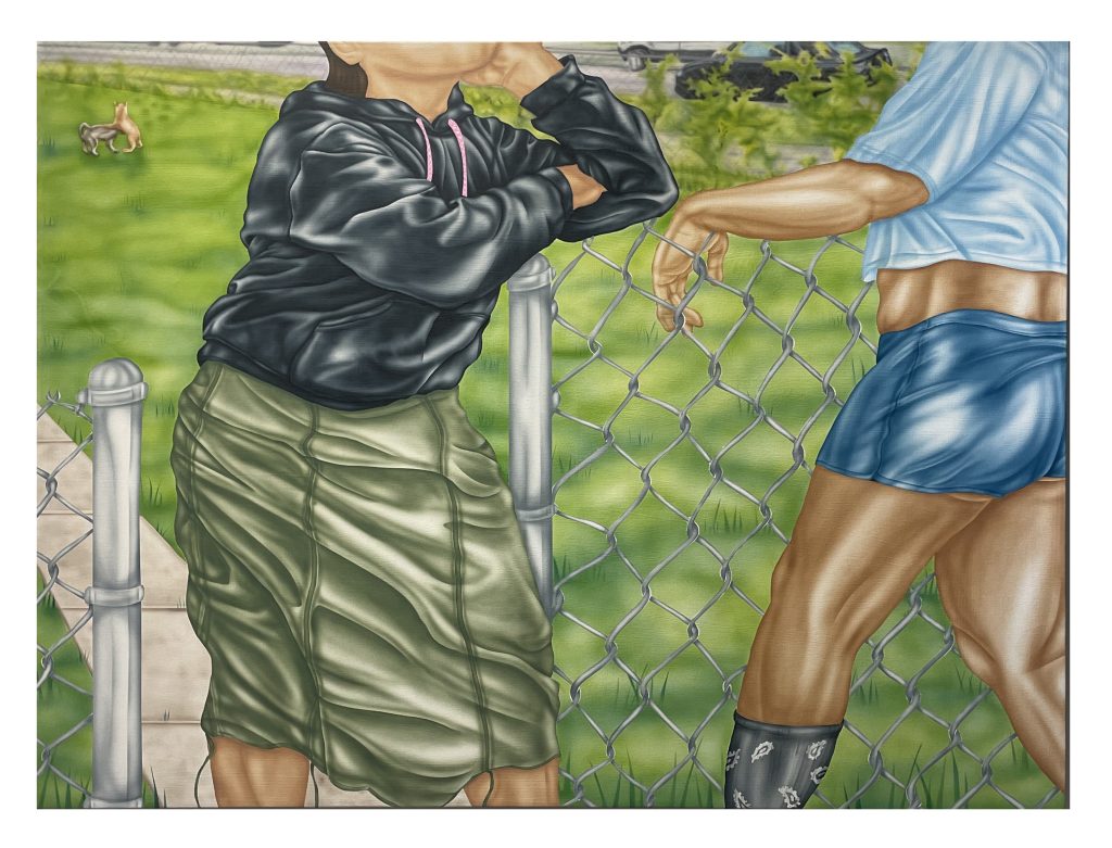 Image: Aguilar’s piece Que Calor details two people hanging in a lush green yard by a chain link fence with their faces out of frame. Photo courtesy of the artist.