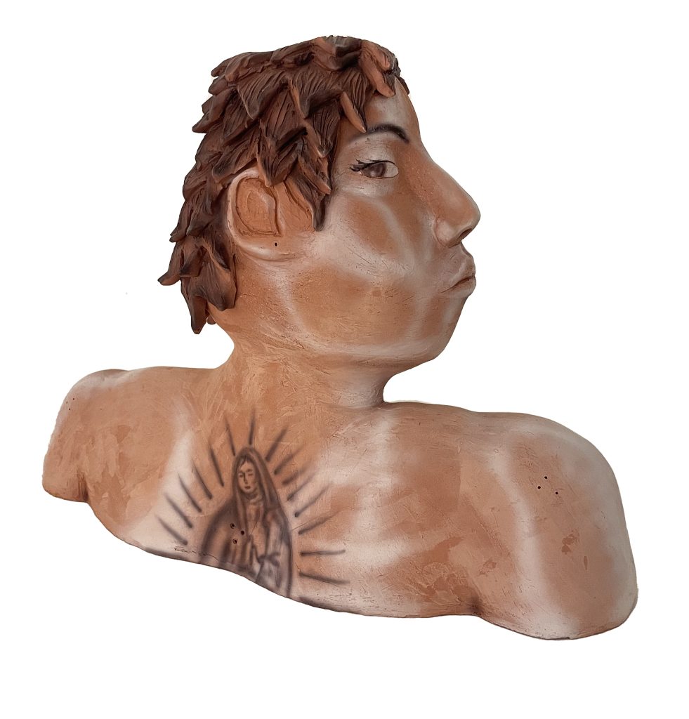 Image: On a white background, Aguilar's sculpture, Who's that. It is a brown person exposing neck, shoulders, and a back tattoo of La Virgen de Guadalupe. Photo courtesy of the artist.