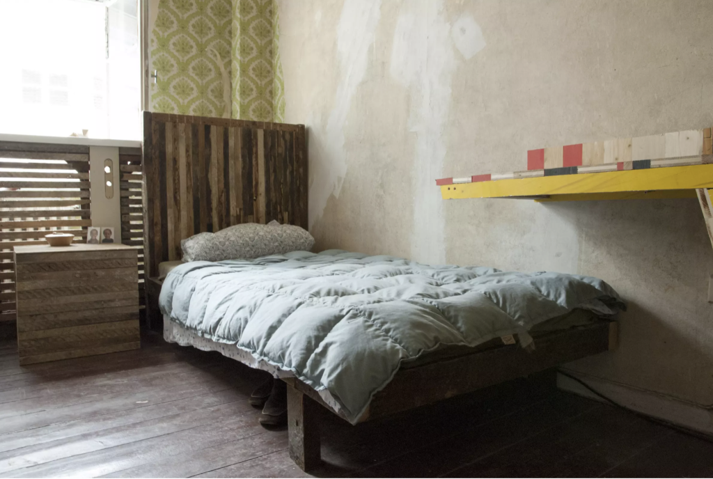 Image: 12 Ballads for Huguenot House at dOCUMENTA (13) in Kassel, Germany. The photo shows a room with wood on the walls and floors, a bed against the wall, and a yellow wall shelf on the right. Photo: ReportArch/Andrea Ferro Photography
From the article:https://www.nytimes.com/2023/05/20/arts/design/plastic-venice-biennale.html
