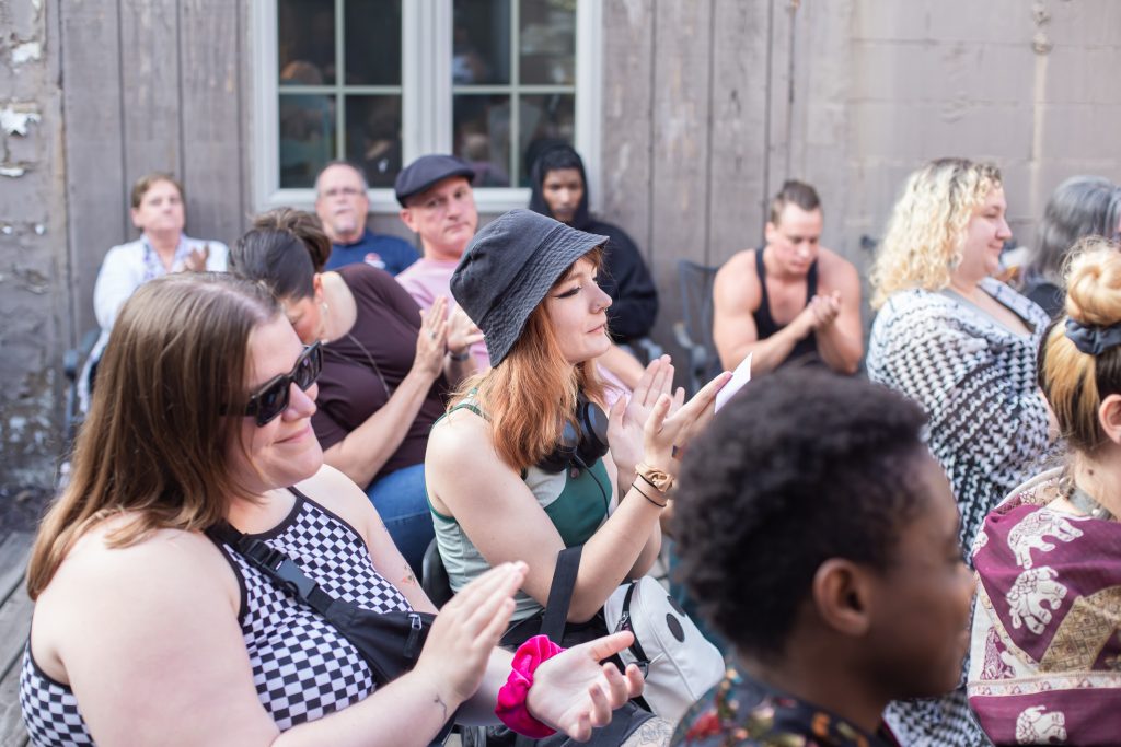 Image: A crowd of people are clapping. Photo by Alexa Cary.