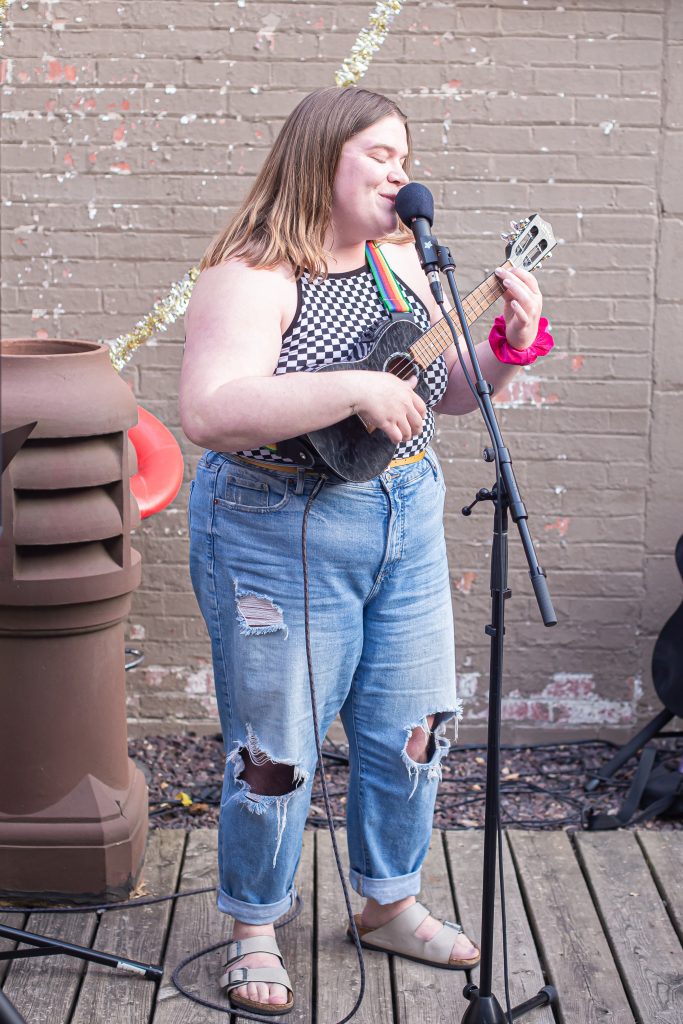 Image: A person participates in CANJE's open mic by singing and playing ukulele. Photo by Alexa Cary.