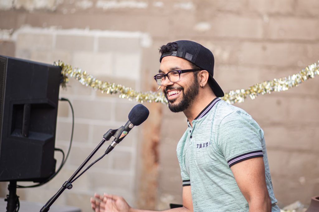 Images: A close up of one of CANJE's open mic participants performing at the event. Photos by Alexa Cary.