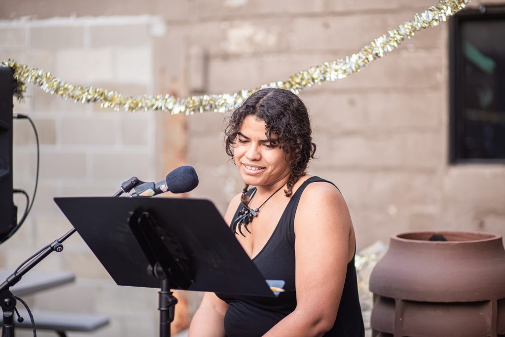 Images: A close up of Brenda Pagan reading her poetry at the CANJE open mic event. Photo by Alexa Cary.