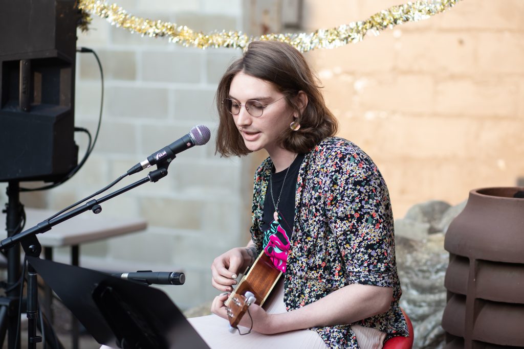 Images: A close up of one of CANJE's open mic participants performing at the event. Photos by Alexa Cary.