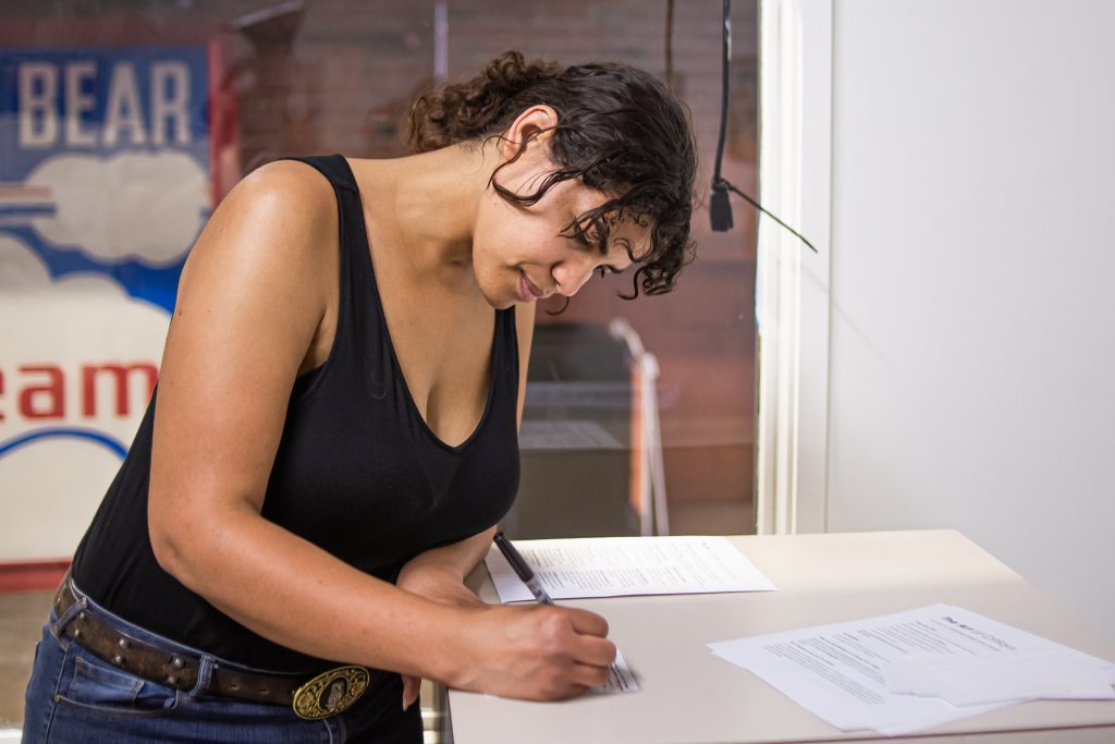 Image: Brenda Gentry writes her feedback for works in the exhibition The Art of Critique. Photo by Alexa Cary.