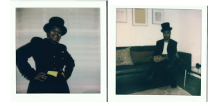 Image: Polaroid captures of Janelle Miller and Jared Brown. Miller and Brown are both wearing black top hats and suits in a room with white walls. Miller is standing with her hands on her hips. Brown is seated on a black couch. Photo by Gabrielle Octavia Rucker.