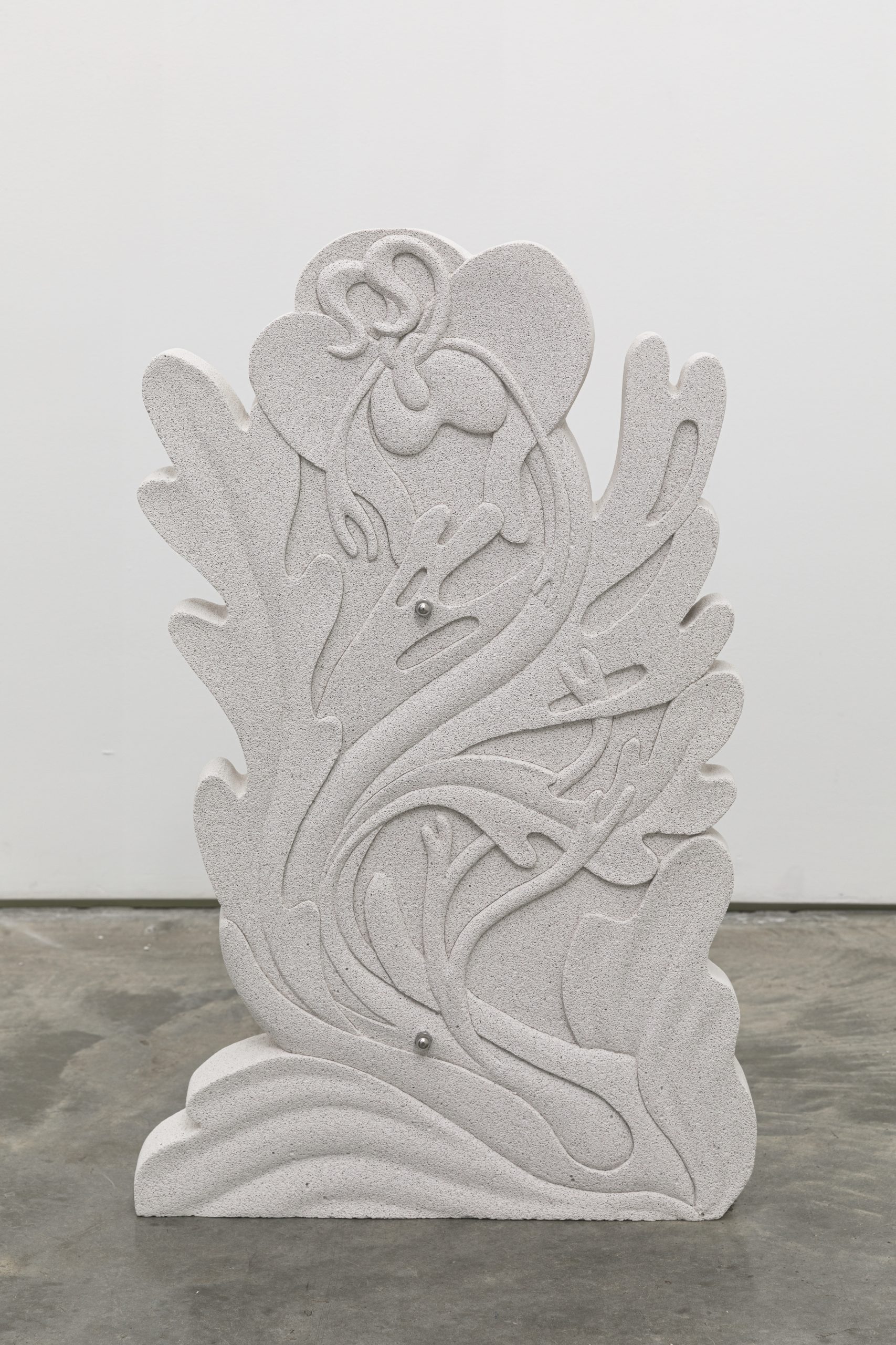 Image: Sif Itona Westerberg, Glitch/Growth II, 2022. Image credit: courtesy of the artist and Gether Contemporary, Copenhagen. A cast concrete depicts a flower growing upward, surrounded by flowing leaf fronds. Two steel bolts are visible in the lower and upper half of the cast.