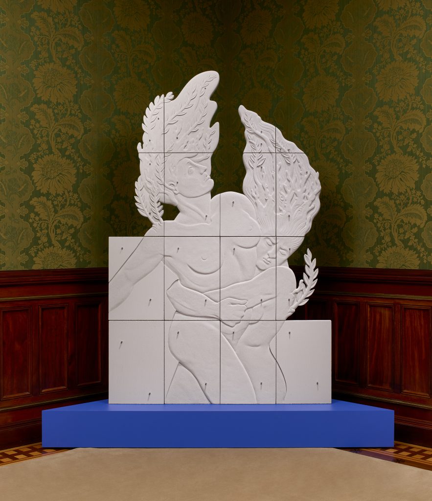Image: Sif Itona Westerberg, The Heliades Turned Into Poplar Trees, 2021. Image credit: Brian Griffin. Two figures appear in cast concrete, presented on a blue plinth. The right figure embraces the left around her waist, her face downturned and pained. The left figure looks upward, expressionless. Both have tree branches sprouting from their heads. Steel bolts dot the cast concrete forms. 
