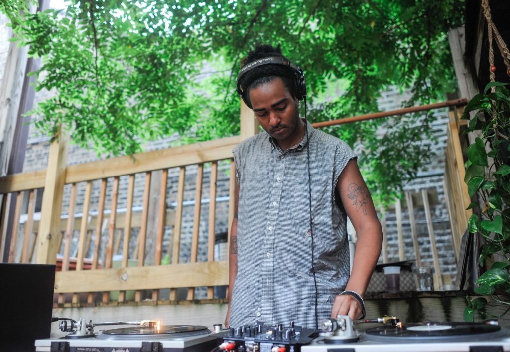 Image: Jared Brown djs outside in celebration at the 2018 Chicago Archives + Artists Festival. Photo by William Carmago.