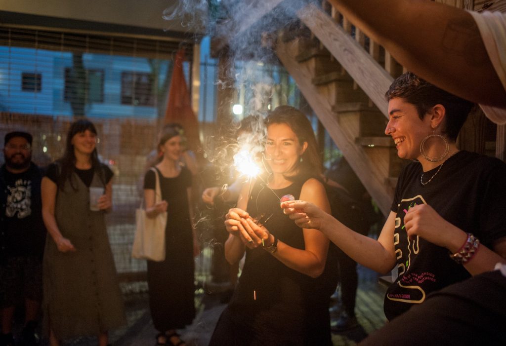 Image: A group of festival goers outside lighting sparklers in celebration at the 2018 Chicago Archives + Artists Festival. Photo by William Carmago.