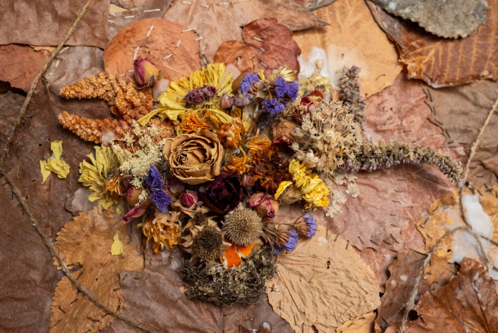 Image: Close up of darien golston, five foot four inches forward in the fight for freedom. A patchwork of dried leaves stitched together around a center of dry flowers. Photo by Tonal Simmons.