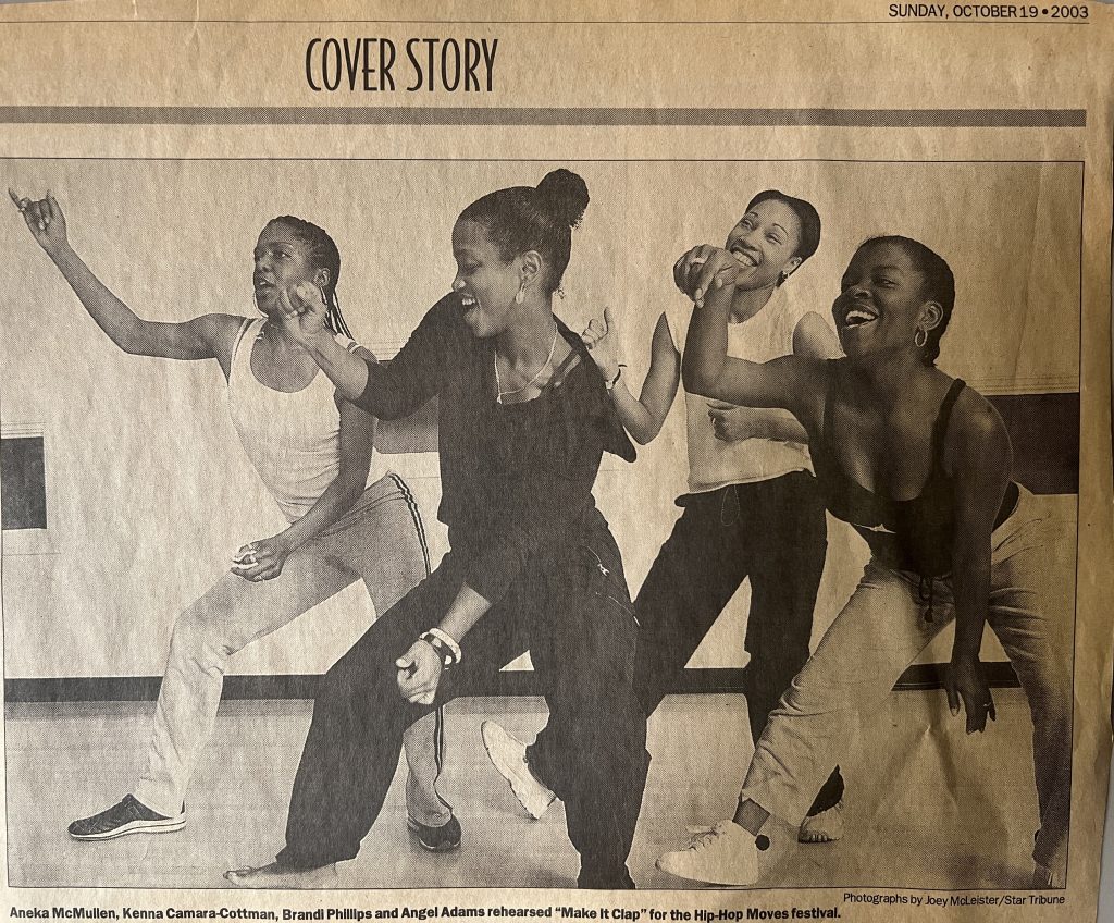 Image: Newspaper cutout of four dancers mid-practice. Photo of Black Pearl, Kenna Cottman's dance group, 2003. Photo courtesy of writer.