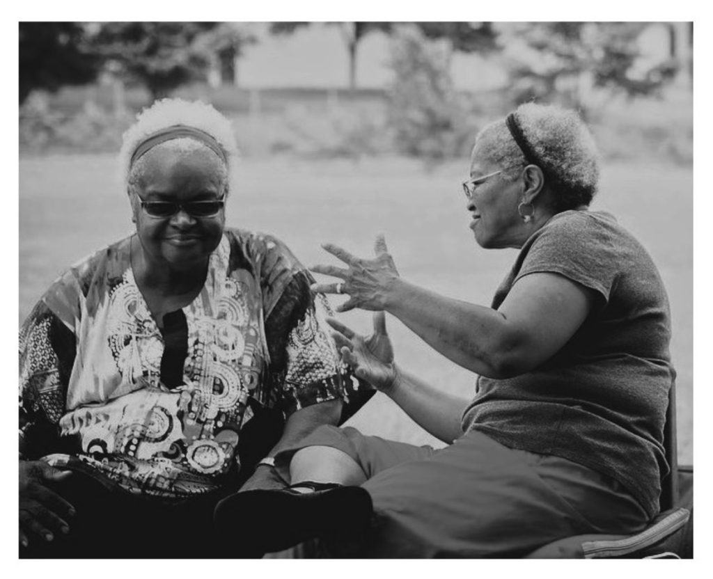 Image: Two women mid-conversation. Beverly Cottman and Mother Nothando Zulu. Photo courtesy of writer.