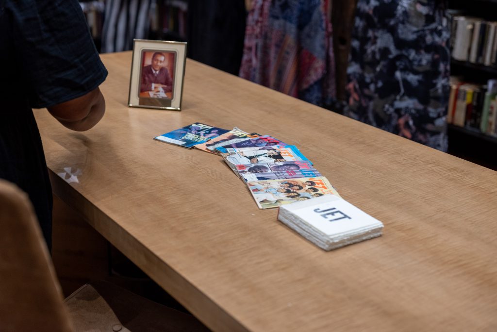 Image: Issues of JET magazine are spread across the table in the Stony Island Art Bank featuring a photo of John Johnson next to them. Photo by Tonal Simmons.