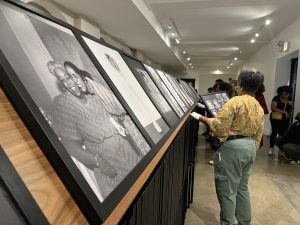 Image: A guest engages with the Fascimile of Women Origin Stories at the Stony Island Art Bank. September 12, 2024. Photo by Tonal Simmons.