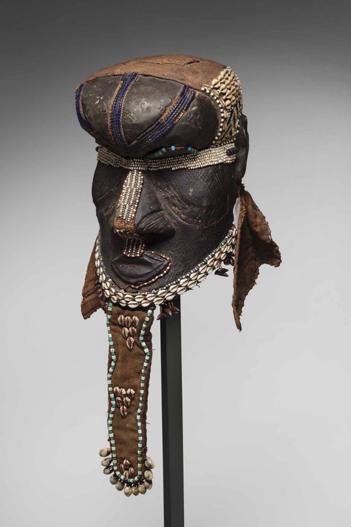 Image:  Kuba Peoples, Democratic Republic of Congo
Helmet Mask: Bwoom, 1875-1900. Wood with leather, brass, fabric, cowrie shells, beads. Image courtesy of Toledo Museum of Art.