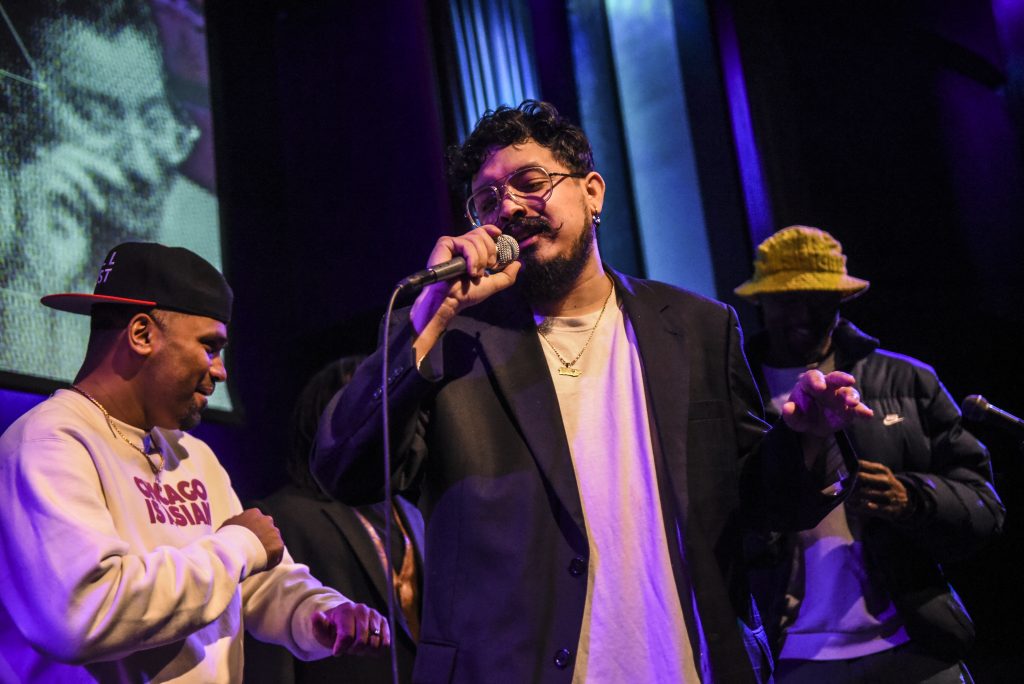 Image: Foto capturing the finale performance at Old Town School of Folk Music, Lester Rey is performing "Pena," a song first released in 2017 and later reimagined by local producer Afroqbano. Digital foto by Carolina Sánchez. 