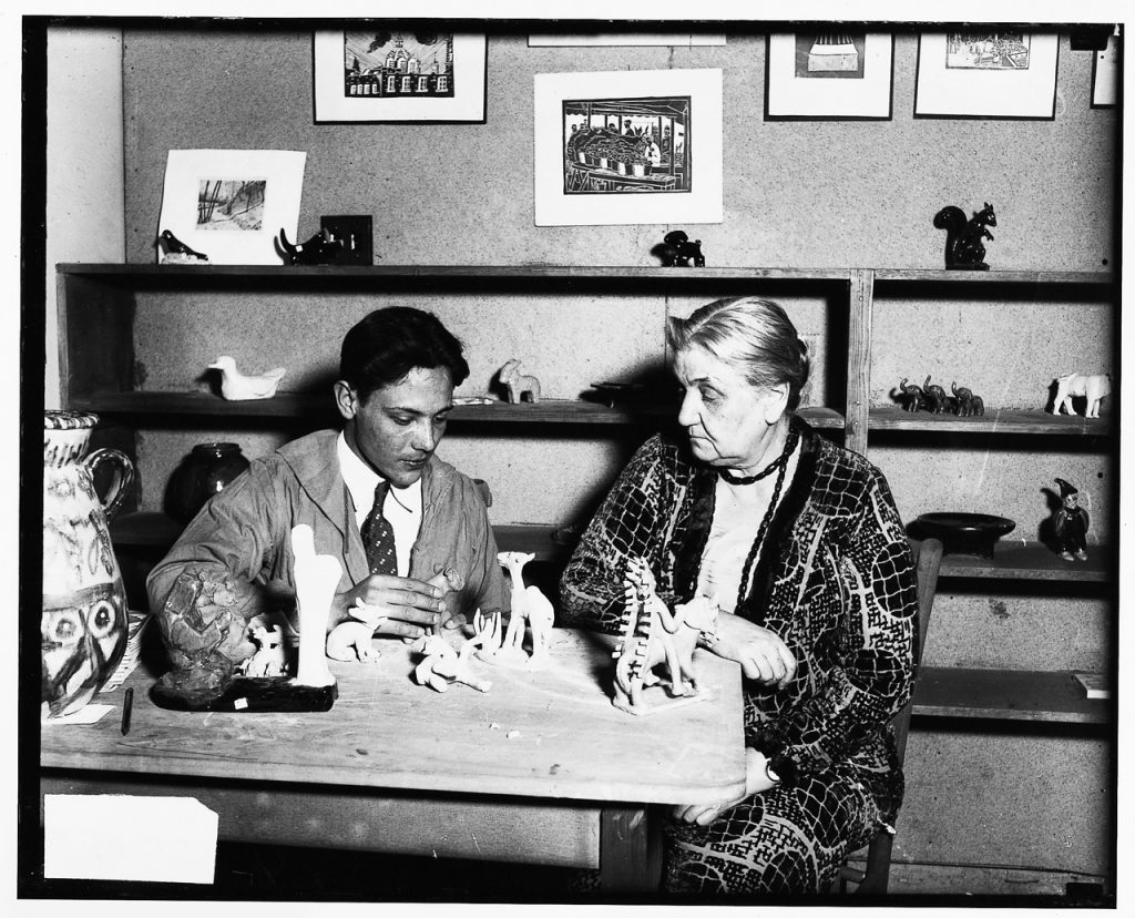 Image: Hilarion Tinoco and Jane Addams seated at a table looking at animal ceramic figurines, n.d. Hull-House Photograph Collection, Special Collections, University of Illinois Chicago. Courtesy of Jane Adams Hull-House Museum.