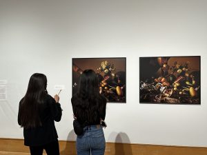 Image: Two visitors observing archival inkjet prints from the exhibition. Image courtesy of the Des Moines Art Center.