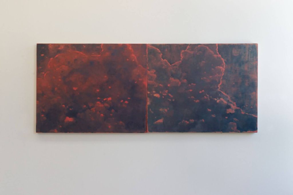 Image: Braden Bandel, Cloud Diptych, 2019. Two oil painting panels are seamlessly placed side by side to form a diptych, depicting a cluster of clouds in deep brown and orange-red tones. Photo by Tianjiao Wang.