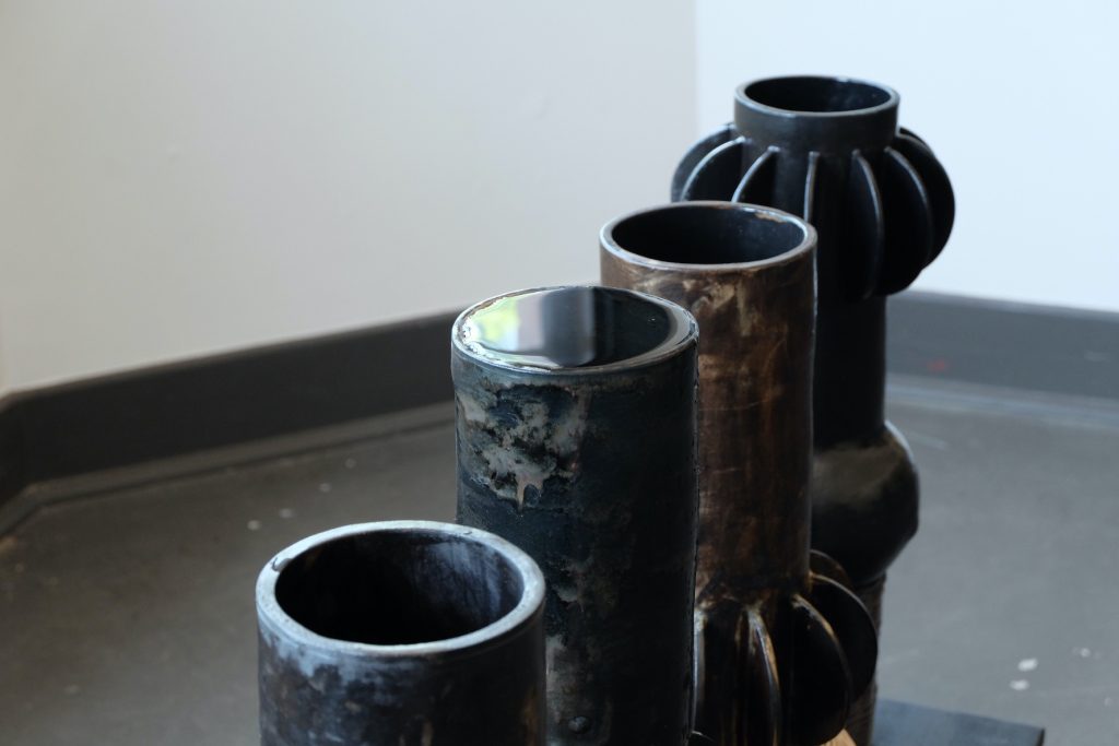 Images: ebere agwuncha, nsude 1-5 featured in owoko at Comfort Station, 2022. Documentation of ebere and a visitor participating in the water pouring ritual with select owoko vessels. Photo credit: B. Sanborn.