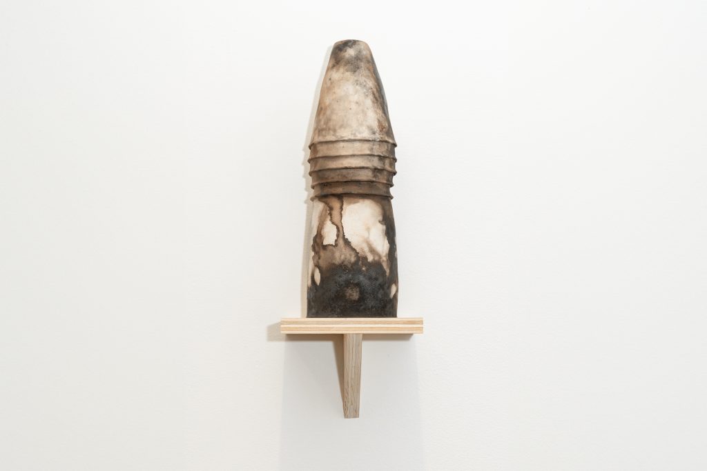 Image: ebere agwuncha, vessel blessing featured in soft structures at Chicago Artist Coalition, 2024. Ceramic pit-fired vessel sits on a wood shelf. Photo credit: Lyric Newbern.