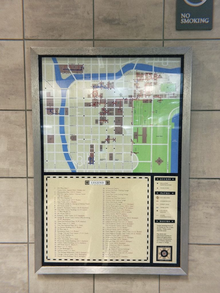 Image: Map of the pedway system hung on the wall of the pedway tunnel shown under a black and white "No Smoking" sign. Image by Livy Snyder.