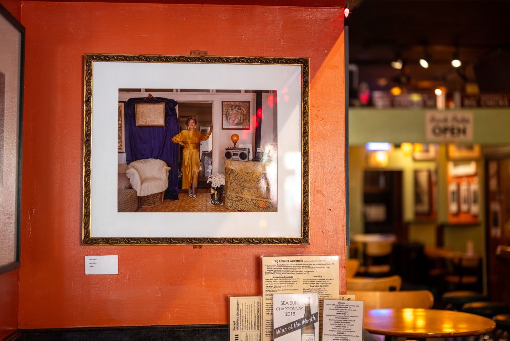 Image: (1-6, above) Fire’s art collection continues to adorn the walls. Various framed art hang on the walls at Big Chicks. Some walls are orange, some green, and some pale yellow. Images by Tonal Simmons.