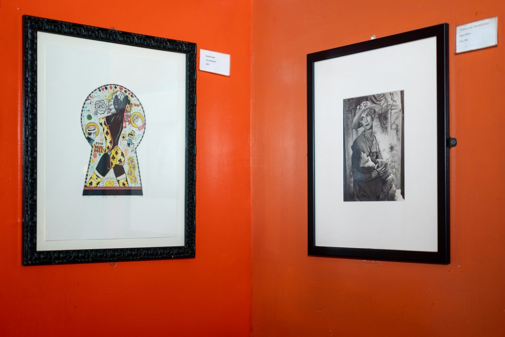 Image: (1-6, above) Fire’s art collection continues to adorn the walls. Various framed art hang on the walls at Big Chicks. Some walls are orange, some green, and some pale yellow. Images by Tonal Simmons.