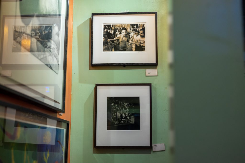 Image: (1-6, above) Fire’s art collection continues to adorn the walls. Various framed art hang on the walls at Big Chicks. Some walls are orange, some green, and some pale yellow. Images by Tonal Simmons.