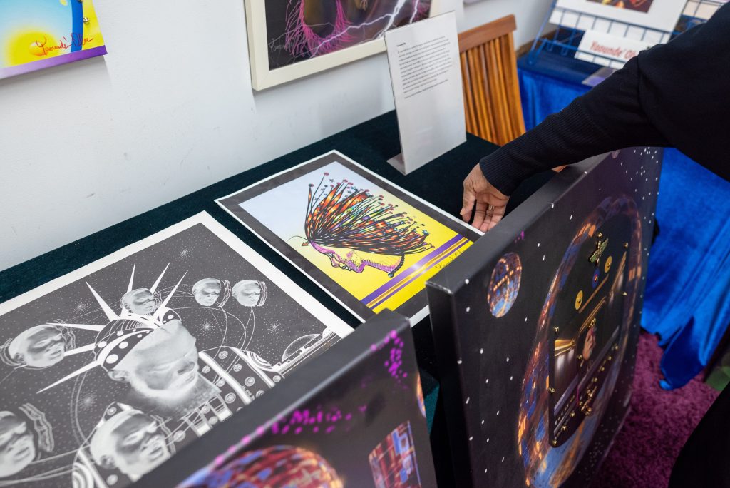 Image: Yaoundé Olu reaches to pick up a print of her painting on the stable of her showroom. Image by Tonal Simmons.