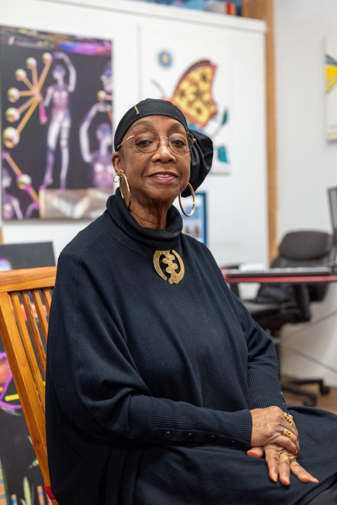 Image: Olu sits on a chair in her studio. Image by Tonal Simmons.