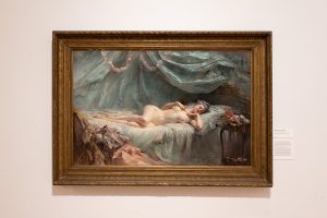 Image: Installation view of The First Homosexuals: The Birth of a New Identity, 1869-1939, at Wrightwood 659, 2025. An oil painting of a nude female figure lying on a bed is presented in a gilded frame. Photo courtesy of Daniel Eggert (@DesigningDan).