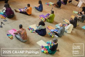 Image: A photo of a group of archivists and artists at the 2024 Chicago Archives + Artists Festival participating in a group performance facilitated by artist Nati Villanueva Linares. Photo made by Kristie Kahns.