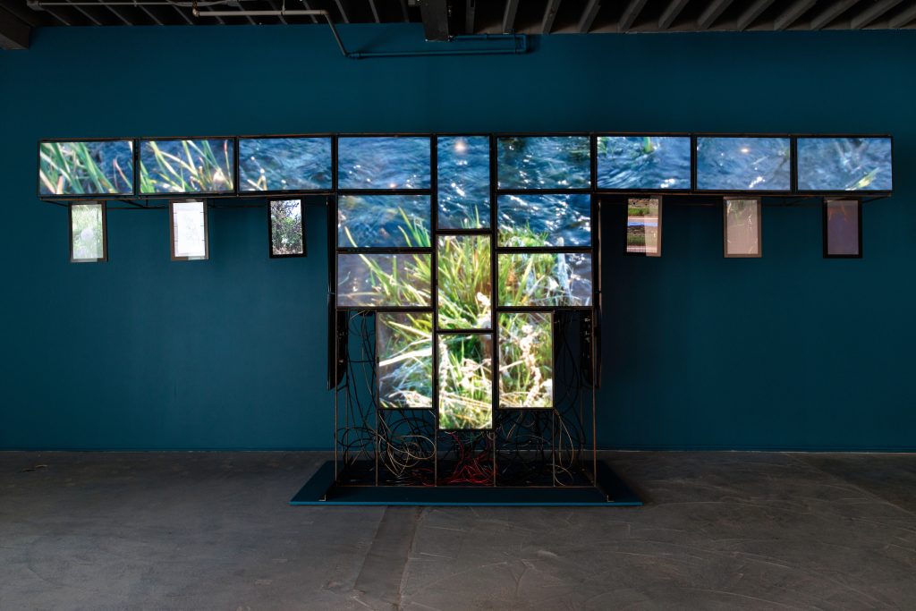 Image: Bentley Spang's War Shirt #6—Waterways, 2017, Televisions, digital stills, steel, video players, cabling, ethernet, bridge, wood. Courtesy Bently Spang and Mountain Time Arts. Image courtesy Bemis Center for Contemporary Arts. Photo by Colin Conces. 