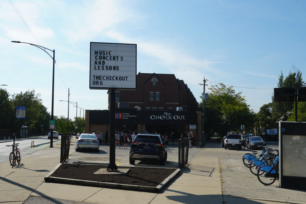 The streetview of The CheckOut. There's a sign in front of the building that reads "Music Concerts and Lessons. The CheckOut Org." Photo by Alannah Spencer. Courtesy of Access Contemporary Music.