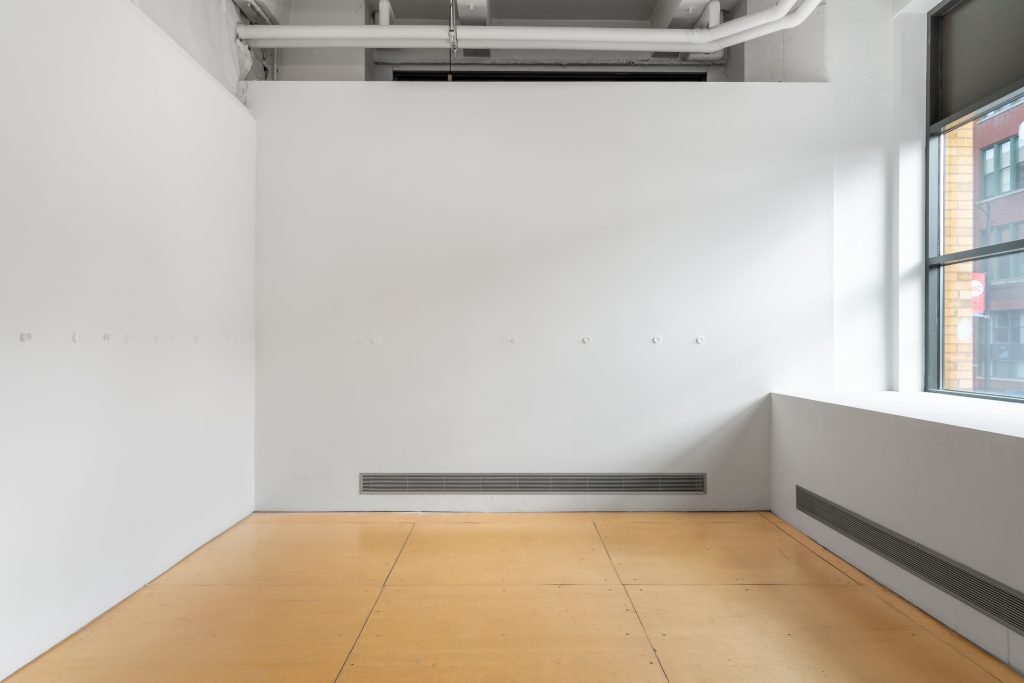 Image: Installation view, "A toxin threatens, but it also beckons," 2025. Gallery 400. White cube gallery space with plastic crucibles affixed to the wall of the same color. Image courtesy of Prairie, Chicago.