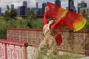 Image: Irene Hsiao dancing on the bridge. Guardians of the Earth and Sky at Ping Tom Park, August 23, 2025. Photo by Scott Shigley.
