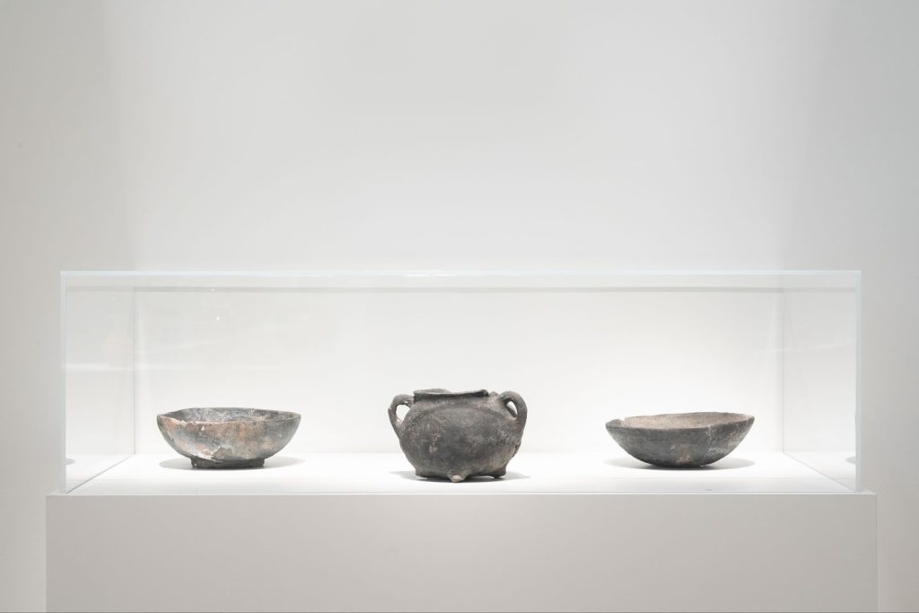 Installation View, “Black Defined 1: Ceramics,” 2025. Milwaukee’s Bronzeville Center of the Arts. Three examples of colonoware (a pot with two plates on either side) with an ash-to-rust patina. Photo: Daniel McCullough.