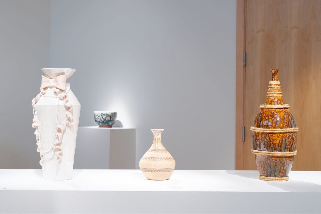 Installation View, “Black Defined 1: Ceramics,” 2025. Milwaukee’s Bronzeville Center of the Arts. Three vases of varying size and color on a white plinth. Photo: Daniel McCullough.