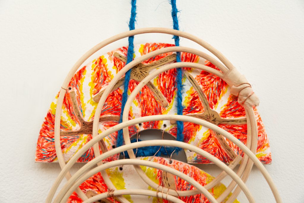 Sending a Picture (broken bi), 2026. A sculptural form is assembled from colorful half crescent fresco pieces, a length of blue silk rope, copper wire, and several overlapping wooden circles.