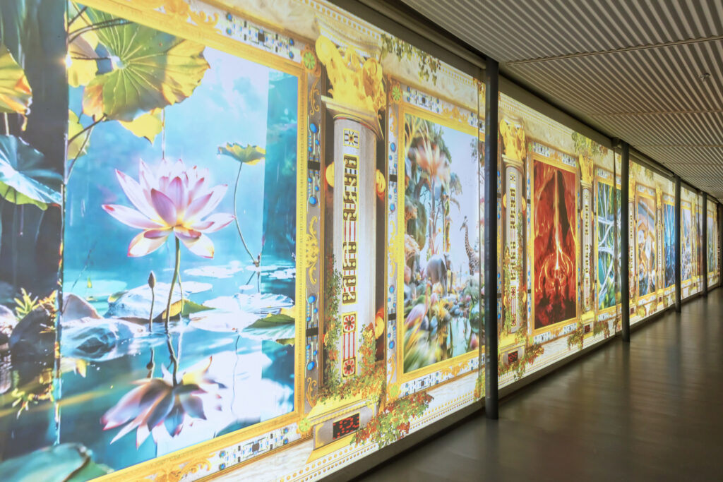 Saṃsāra installation view inside of Hyde Park Center which shows AI generated wall painting of lotus flowers blooming in water and what resembles roots beneath the earth and branches in a forest. Image courtesy Jonathan Michael Castillo.
