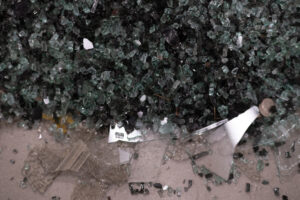 A close-up view of broken tempered glass and debris in A Memorial Takes Place. Documentation by Negin Mirfakhraee.