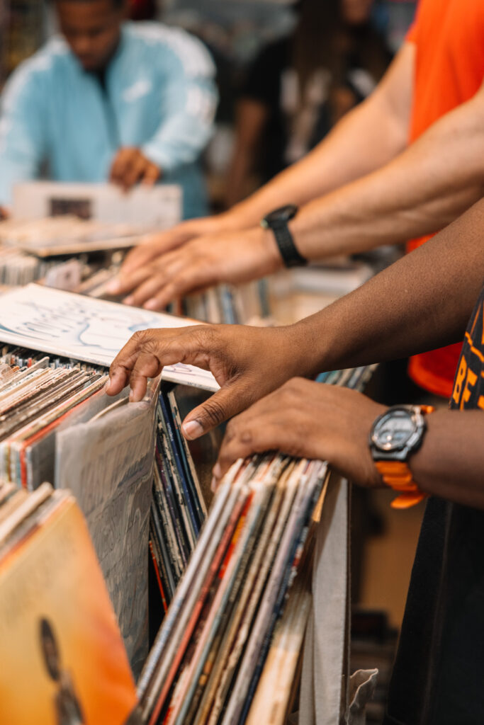 A close-up shot of two people's hands flipping through records. Photo by Wendy Davis. 