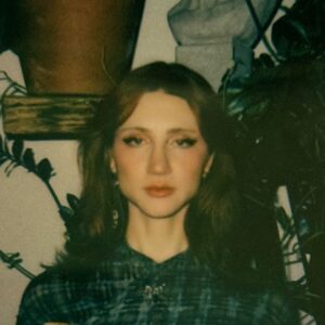 Image: Color polaroid portrait of Riley Yaxley.