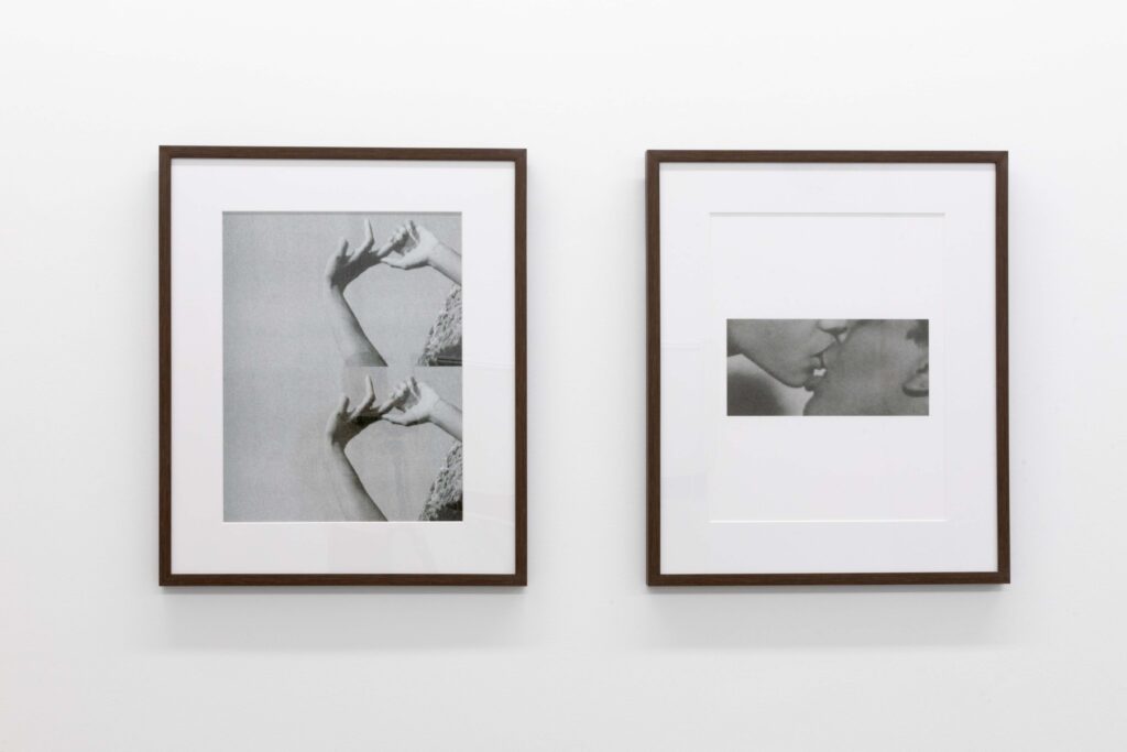 An installation view of: Jen Everett, Untitled, 2023. The two black and white photographs show hands touching (left) and mouths touching (right). The photos were on view as part of the exhibition Beneath the City, a World at The Luminary. Photos by Emily Mueller, courtesy of The Luminary.