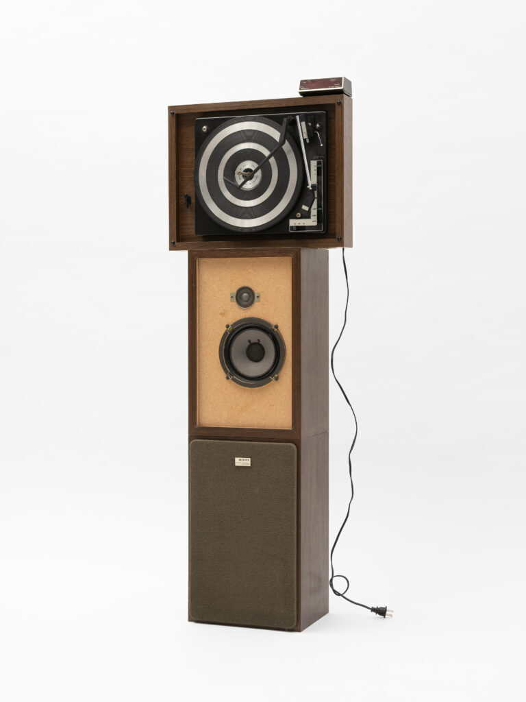 Jen Everett, Untitled, from the series Unheard Sounds, Come Through, 2024. Found objects. Dimensions variable. Installation: 51 x 17.5 x 8.5". The image shows a stack of vintage stereos and other vintage audio equipment. Courtesy of the artist and Rivalry Projects, Buffalo, NY.
