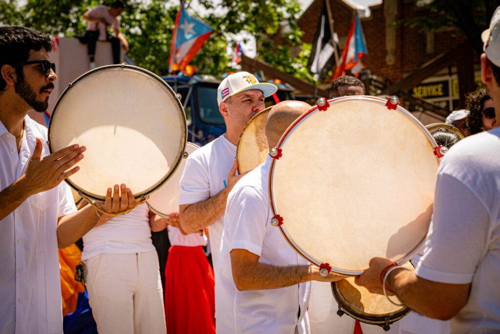 A close-up shot of the panderos being held and played by La Escuelita Bombera de Corazon. Photo by Tonal Mondae. 