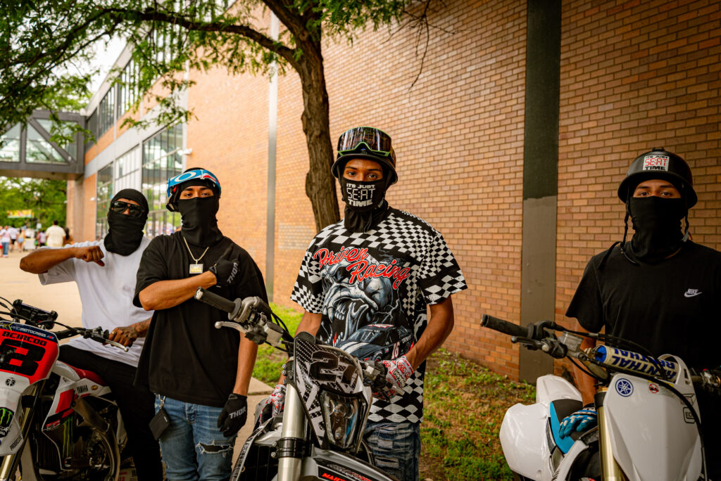 A group of motorcyclists waiting to join their friends pose in front of their bikes. Photo by Tonal Mondae. 